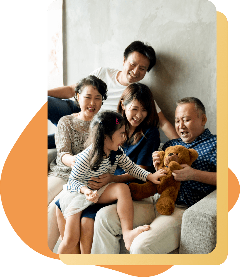 happy 3 generation asian family playing with a teddy bear