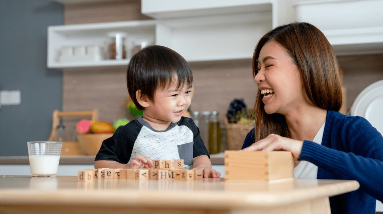 A mother playing wooden jigsaw puzzle with a child